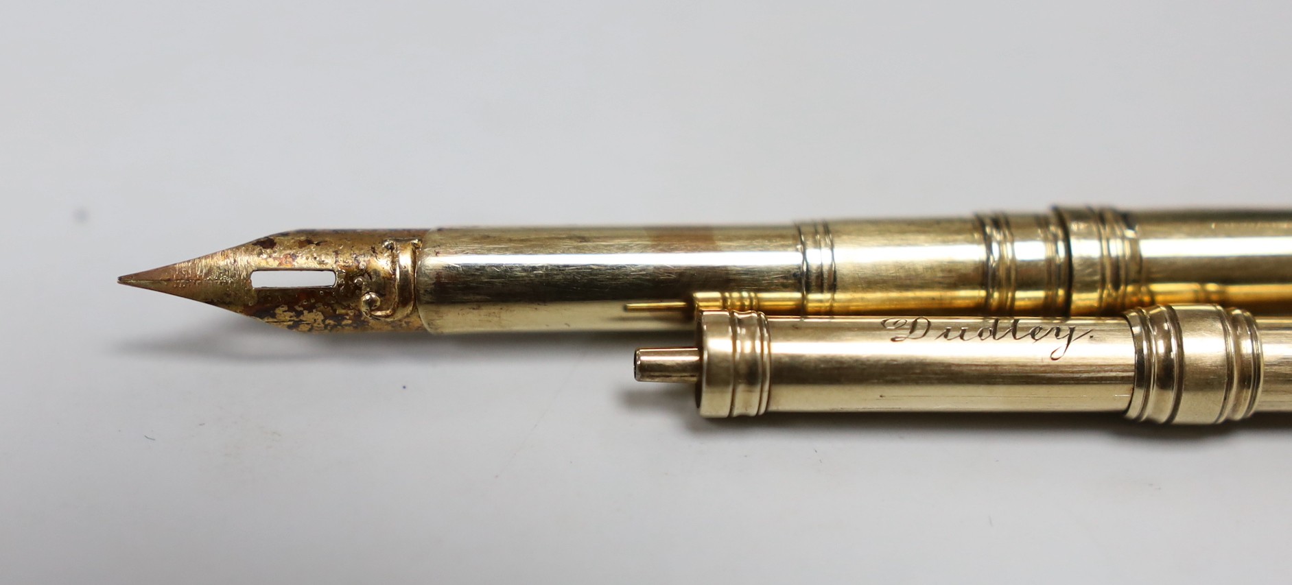A George V 9ct gold dip pen by Sampson Mordan & Co, 12.4cm, 6.8 grams and a Sampson Mordan & Co yellow metal overlaid propelling pencil.